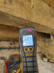 An electronic moisture meter checking the moisture content of timber